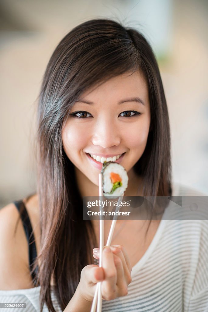 Woman eating sushi