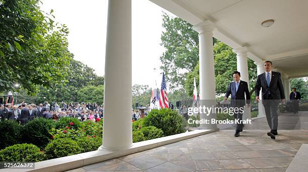 President Barack Obama and South Korean President Lee Myung-bak depart after a news conference in the Rose Garden at the White House in Washington....