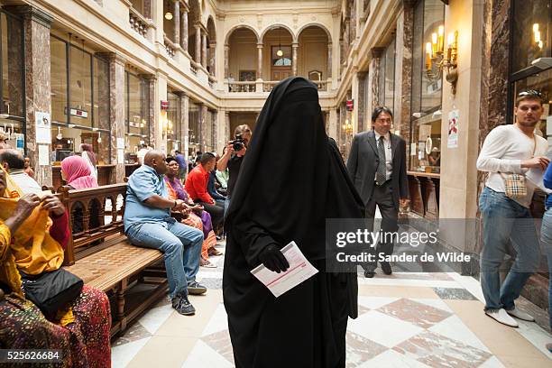 The woman being fined for wearing a face covering veil in public , forbidden in France and Belgium, visited the townhall of Schaarbeek, a community...
