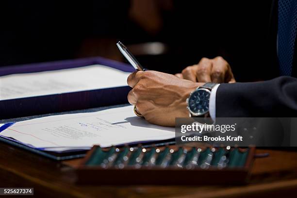 President Barack Obama signs the Family Smoking Prevention and Tobacco Control Act, in the Rose Garden of the White House in Washington.