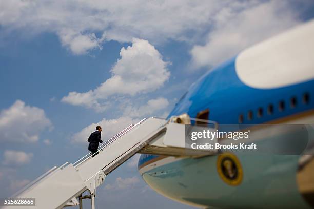 President Barrack Obama climbs the stairs to board Air Force One at Andrews Air Force Base.