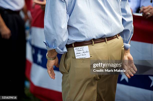 Notes from his introductory speech in his back pocket, Pennsylvania Governor Tom Corbett awaits the arrival of former Massachusetts Gov. Mitt Romney,...