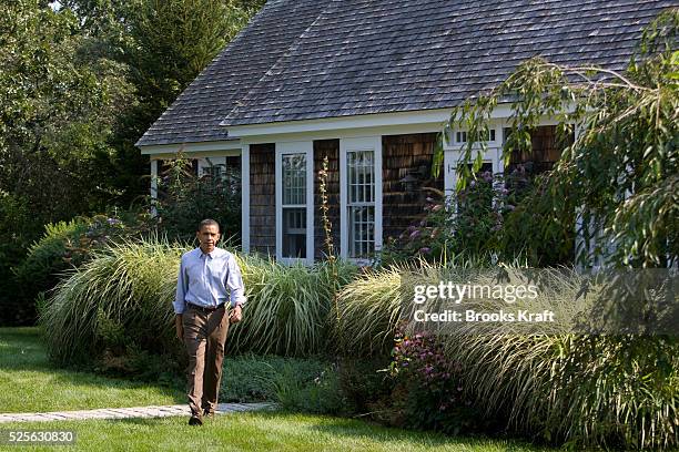 President Barack Obama walks from a building on his vacation compound to make a statement to the press following the death of Senator Ted Kennedy in...