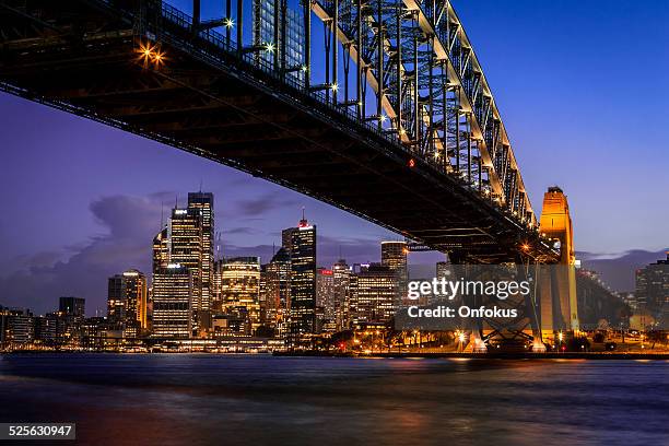 city of sydney cityscape and harbour bridge at dusk - north sydney stock pictures, royalty-free photos & images