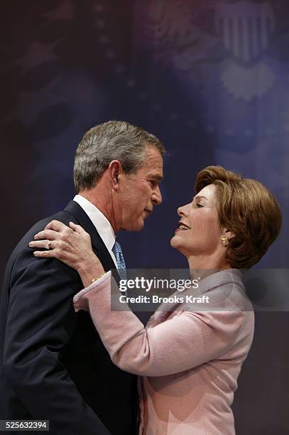President George W. Bush and first lady Laura Bush stand during a speech by Vice President Dick Cheney , during victory celebrations at the Ronald...