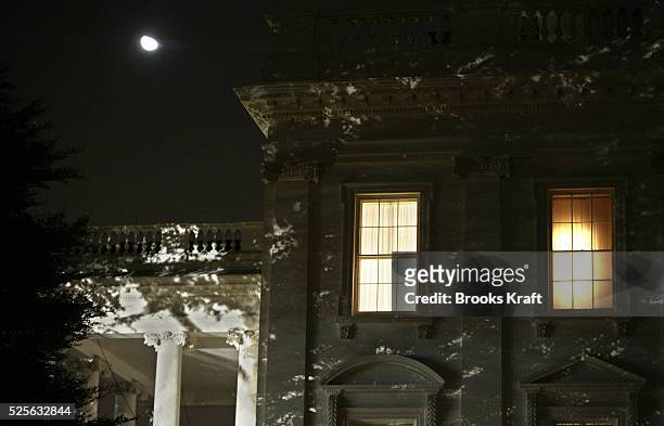 Lights glow from the residence on the top floor of the White House where President George W Bush watched election returns into the night with family...