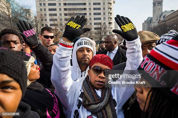 Lesley McSpadden , mother of Ferguson shooting victim Michael Brown, raises her hands up in the air during the 'Justice For All' rally and march...