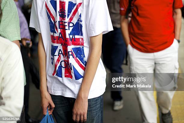 July 29, 2012 - London, England, United Kingdom - A passenger wearing a 'Keep Calm and Carry On' shirt arrives at Custom House station for the ExCel...