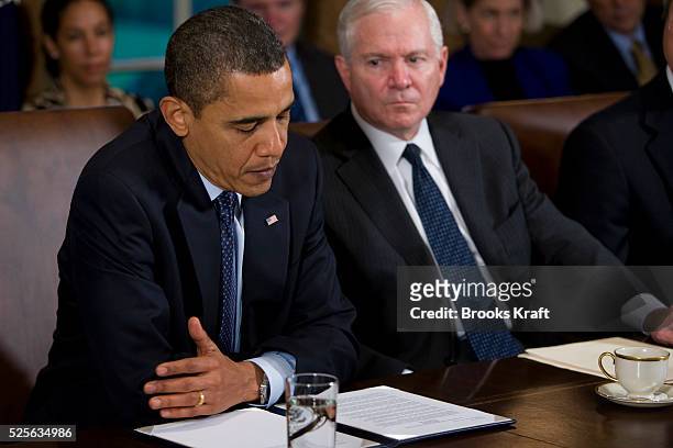 "President Barack Obama, sitting next to Defense Secretary Robert Gates, right, pauses as he speaks during a meeting with members of his Cabinet in...