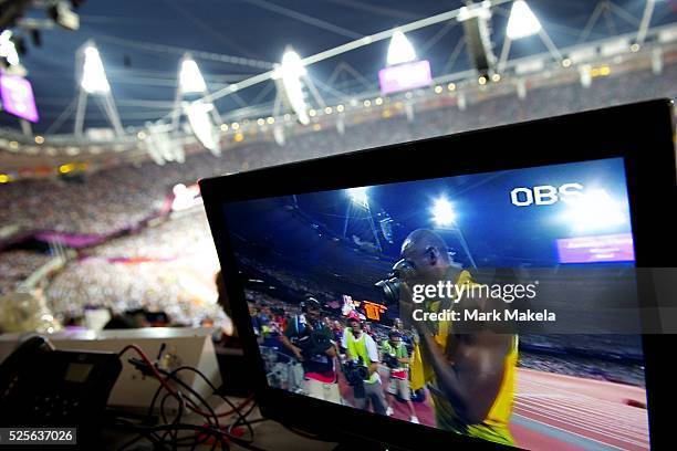 Aug. 9, 2012 - London, England, United Kingdom - As seen on a television monitor within Olympic Stadium, Jamaican sprinter USAIN BOLT borrows a...