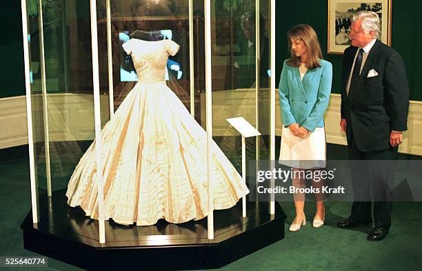 Caroline and Ted Kennedy admire Jackie K's wedding dress on exhibition at the Kennedy library.