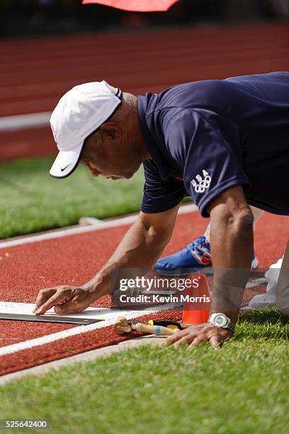 Men's long jump, official carefully replaces takeoff mark