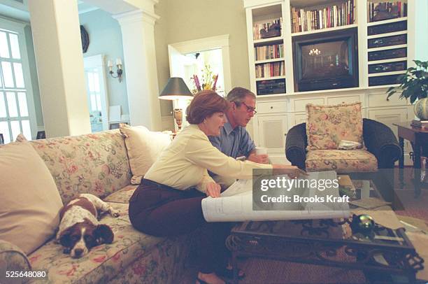 Bush with his wife Laura examining the plans of the ranch they have just purchased at Crawford in Texas.