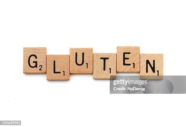 gluten spelled out with scrabble letter tiles - celiac disease stock pictures, royalty-free photos & images