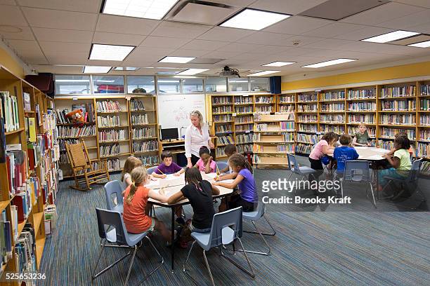 Children read books in a library at Sheridan School in Washington, DC