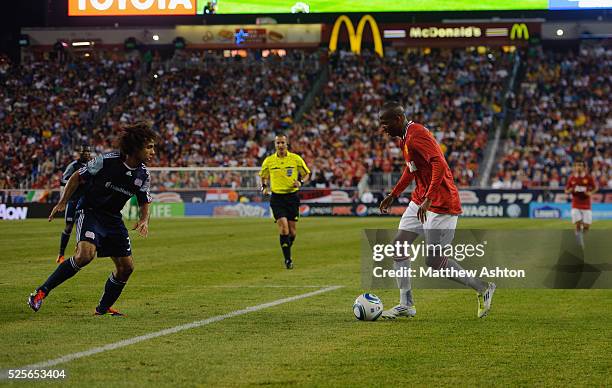 Kevin Alston of New England Revolution tries to defend the attacking Ashley Young of Manchester United