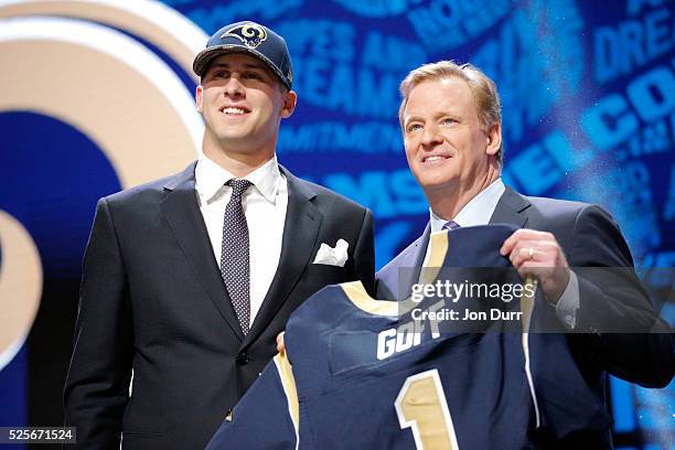 Jared Goff of the California Golden Bears holds up a jersey with NFL Commissioner Roger Goodell after being picked overall by the Los Angeles Rams...