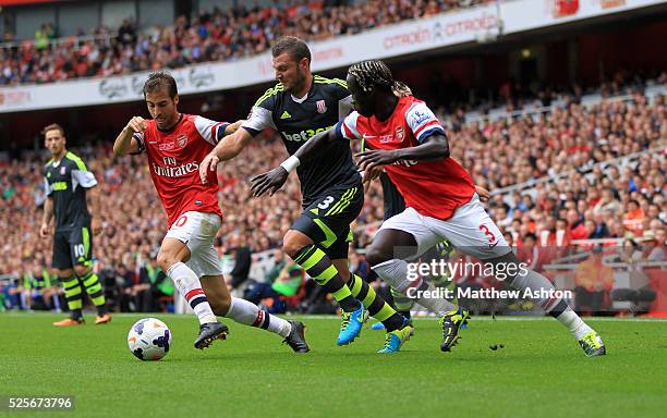 Mathieu Flamini and Bacary Sagna of Arsenal close in on Erik Pieters of Stoke City