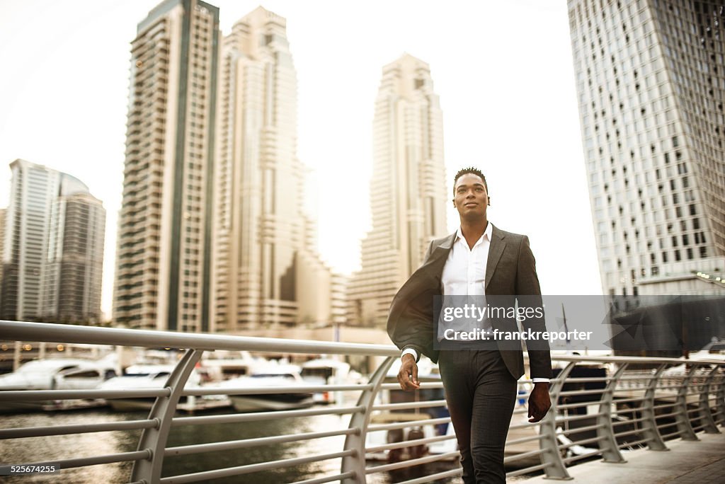 Businessman walking in dubai marina