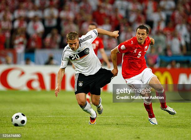 Lukas Podolski of Germany and Dariusz Dudka of Poland during the EURO 2008 preliminary round group B soccer match between Germany and Poland at the...