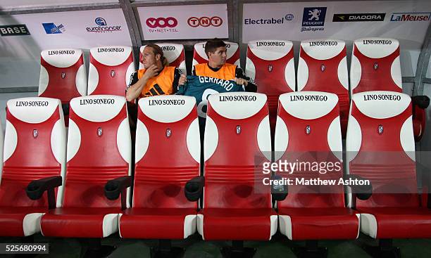 Andriy Voronin of Liverpool and Steven Gerrard sit in the dug out as subs