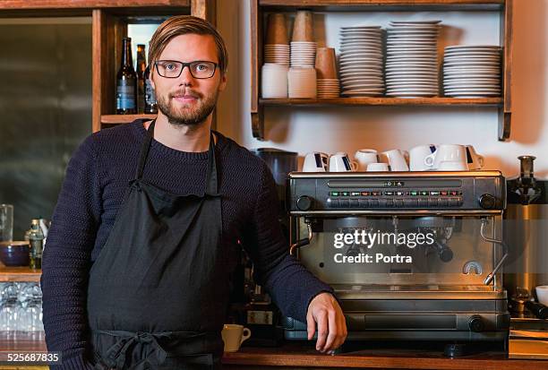 confident male barista standing in restaurant - long sleeve t shirt stock pictures, royalty-free photos & images