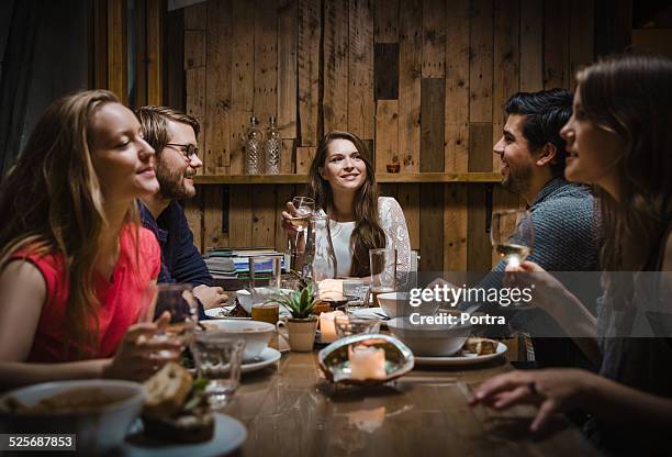 friends having meal at restaurant - food wooden table stock-fotos und bilder