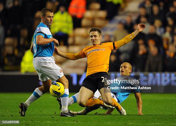 Wes Brown of Sunderland tackles Kevin Doyle of Wolverhampton Wanderers