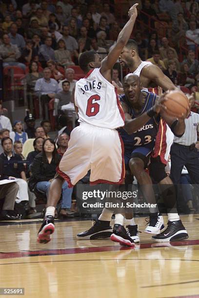 Forward Michael Jordan of the Washington Wizards passes around guard Eddie Jones of the Miami Heat during the NBA game at American Airlines Arena in...