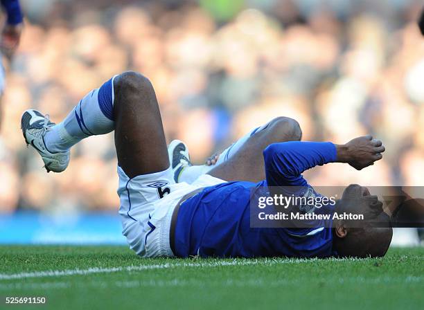 Louis Saha of Everton lies on the floor after being injured in a tackle