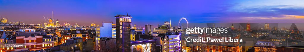 Leicester Square and London skyline at night.
