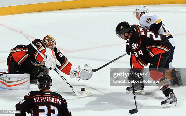 John Gibson of the Anaheim Ducks makes a save as Simon Despres defends against Calle Jarnkrok of the Nashville Predators in Game One of the Western...
