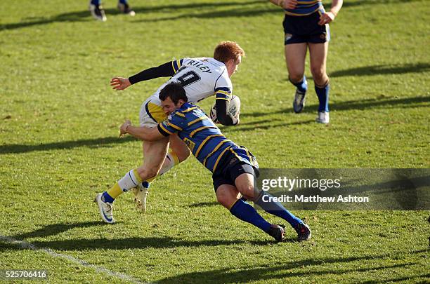 Ryan Hall of Leeds Rhinos tackles Chris Riley of Warrington Wolves