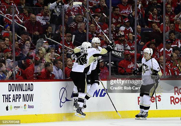 Evgeni Malkin of the Pittsburgh Penguins celebrates his second period goal with teammates Chris Kunitz and Olli Maatta against the Washington...