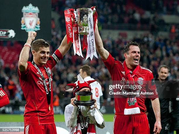 Steven Gerrard and Jamie Carragher of Liverpool lift the Carling Cup Trophy