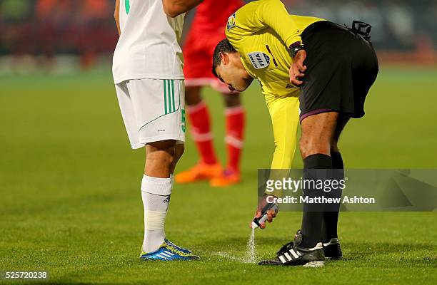 Referee Sandro Ricci from Brazil uses the vanishing spray to indicate 10 yard from the point of a free kick