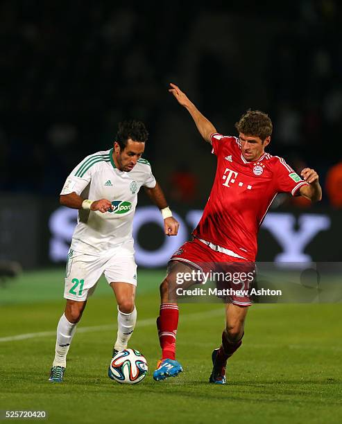 Adil Karrouchy of Raja Casablanca and Thomas Mueller of Bayern Munich