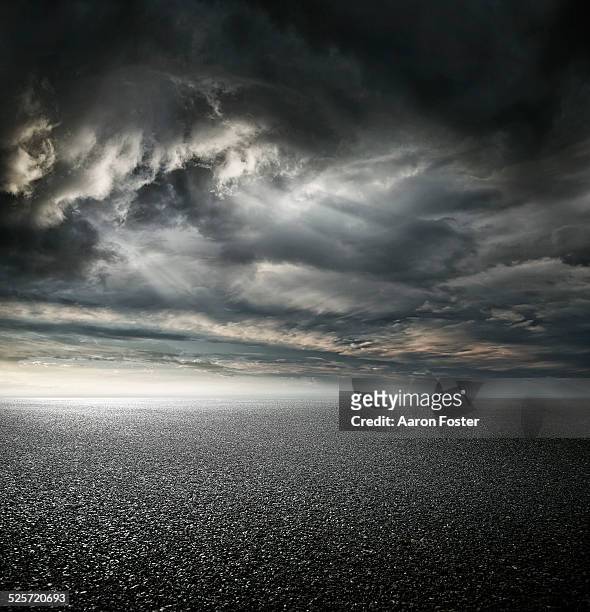 stormy carpark - stormy clouds stock-fotos und bilder