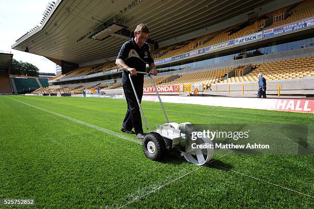 Wolverhampton Wanderers groundsman Terry Carver paints the white lines on the pitch at Molineux Stadium