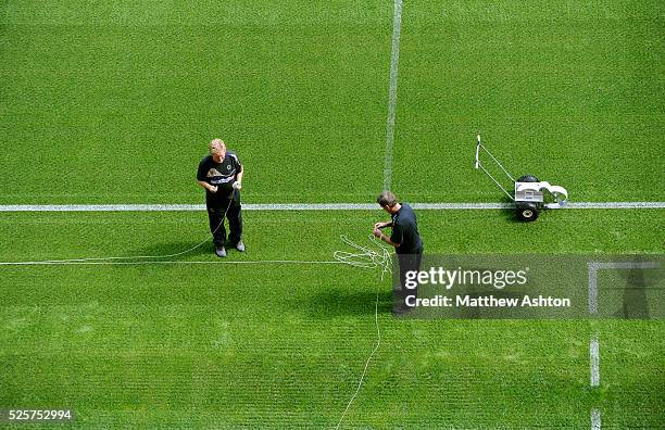 Wolverhampton Wanderers groundsman Terry Carver paints the white lines on the pitch at Molineux Stadium