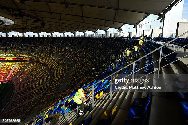 Workers clean the seats in the National Arena / Arena Nationala stadium ahead of the UEFA Europa League Final 2012 - Atletico Madrid v Athletic...