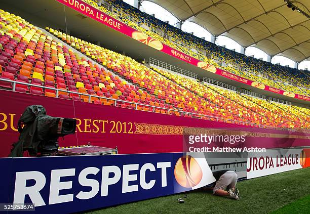 Woker puts up the advertising boards in the National Arena / Arena Nationala stadium ahead of the UEFA Europa League Final 2012 - Atletico Madrid v...