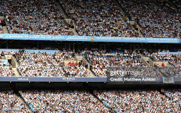 Fans / supporters of Manchester City display a banner reading Manchester thanks you, Sheikh Mansour.