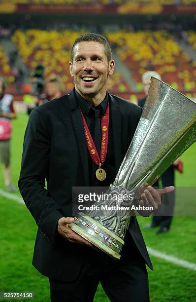 Diego Simeone the head coach / manager of Atletico Madrid celebrates victory with his UEFA Europa League Final 2012 winners medal around his neck and...