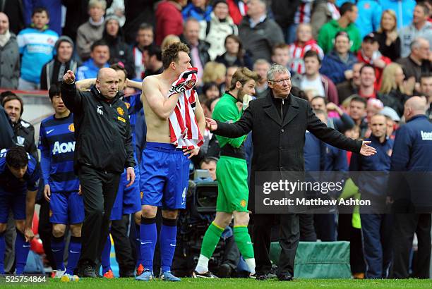 Assistant manager Michael Phelan, Phil Jones of Manchester United and Sir Alex Ferguson the head coach / manager of Manchester United react after...