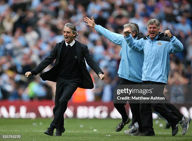 Roberto Mancini the head coach / manager of Manchester City celebrates after Sergio Aguero of Manchester City scores the winning goal to make it 3-2
