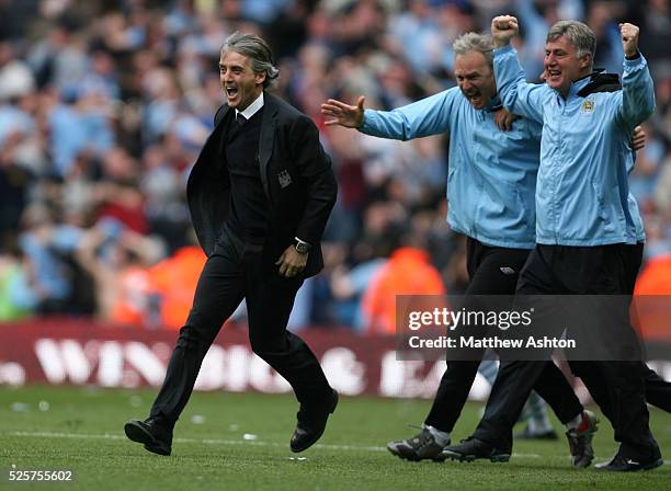 Roberto Mancini the head coach / manager of Manchester City celebrates after Sergio Aguero of Manchester City scores the winning goal to make it 3-2