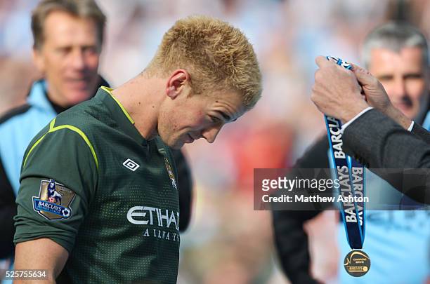 Joe Hart of Manchester City receives his winners medal after Manchester City become champions of the Barclays Premier League 2011/12