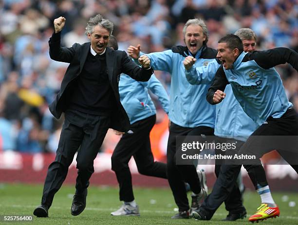 Roberto Mancini the head coach / manager of Manchester City celebrates after Sergio Aguero of Manchester City scores a goal to make it 3-2 and...