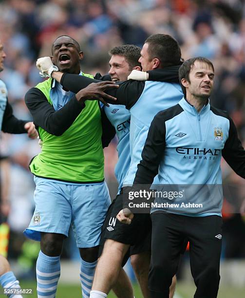 Micah Richards of Manchester City celebrates with some team mates as Sergio Aguero of Manchester City scores the winning goal